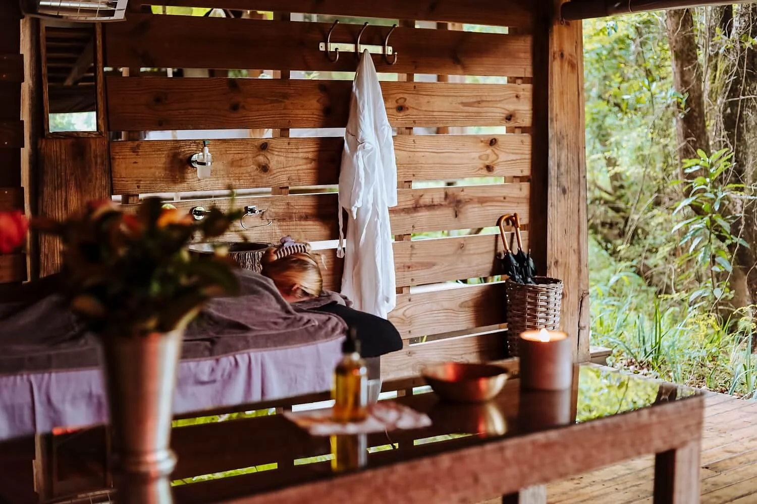 A massage in the outdoor spa surrounded by green